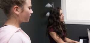 student and teacher singing
