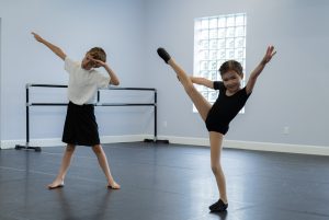 Two students holding their favourite poses in the SIM studios.